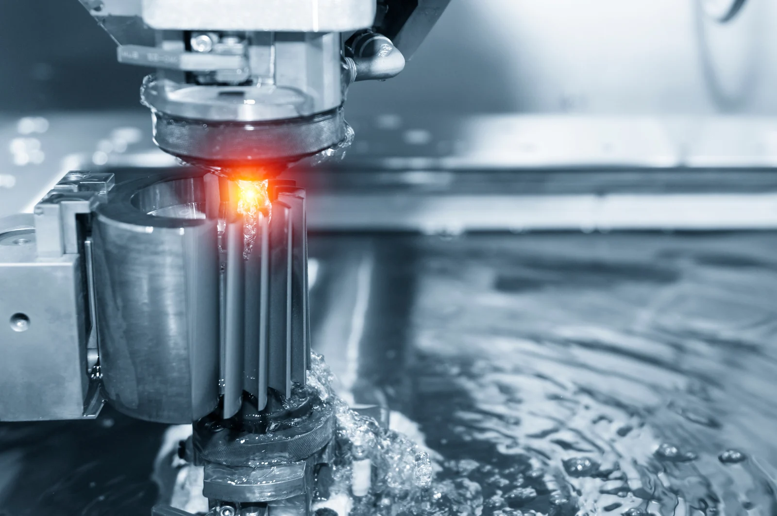 Close-up of electrical discharge machining cutting a metal workpiece