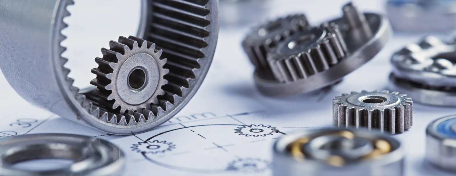 Steel gears and bearings arranged on a technical engineering drawing