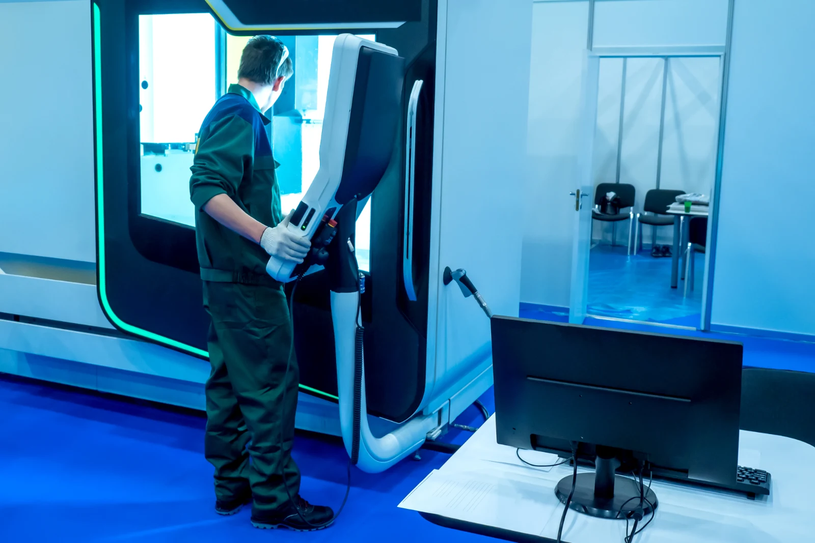 Technician working at an industrial additive manufacturing machine
