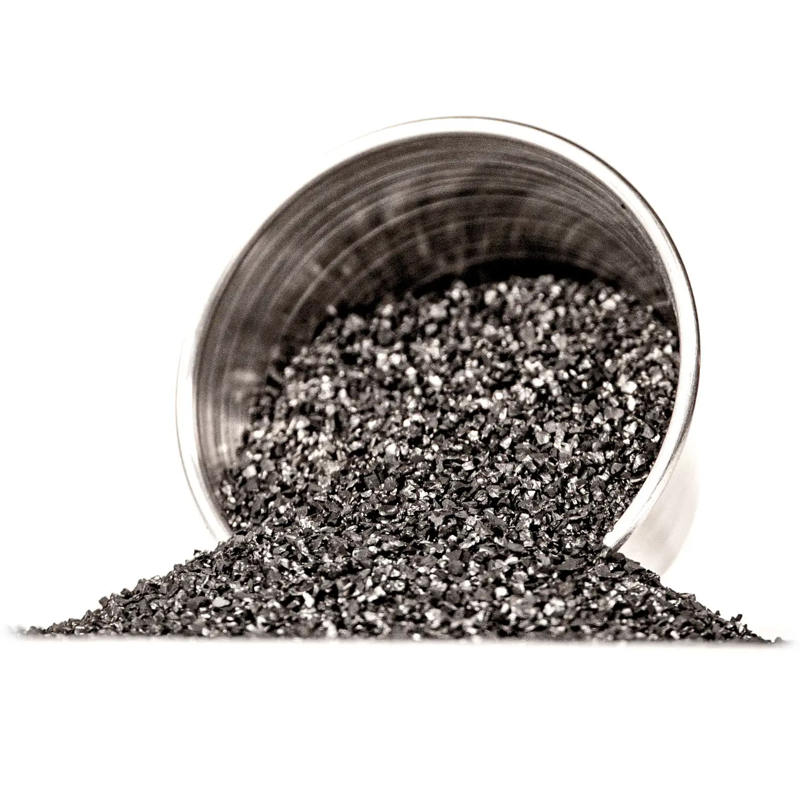 Titanium alloy granulate pouring from a steel cup