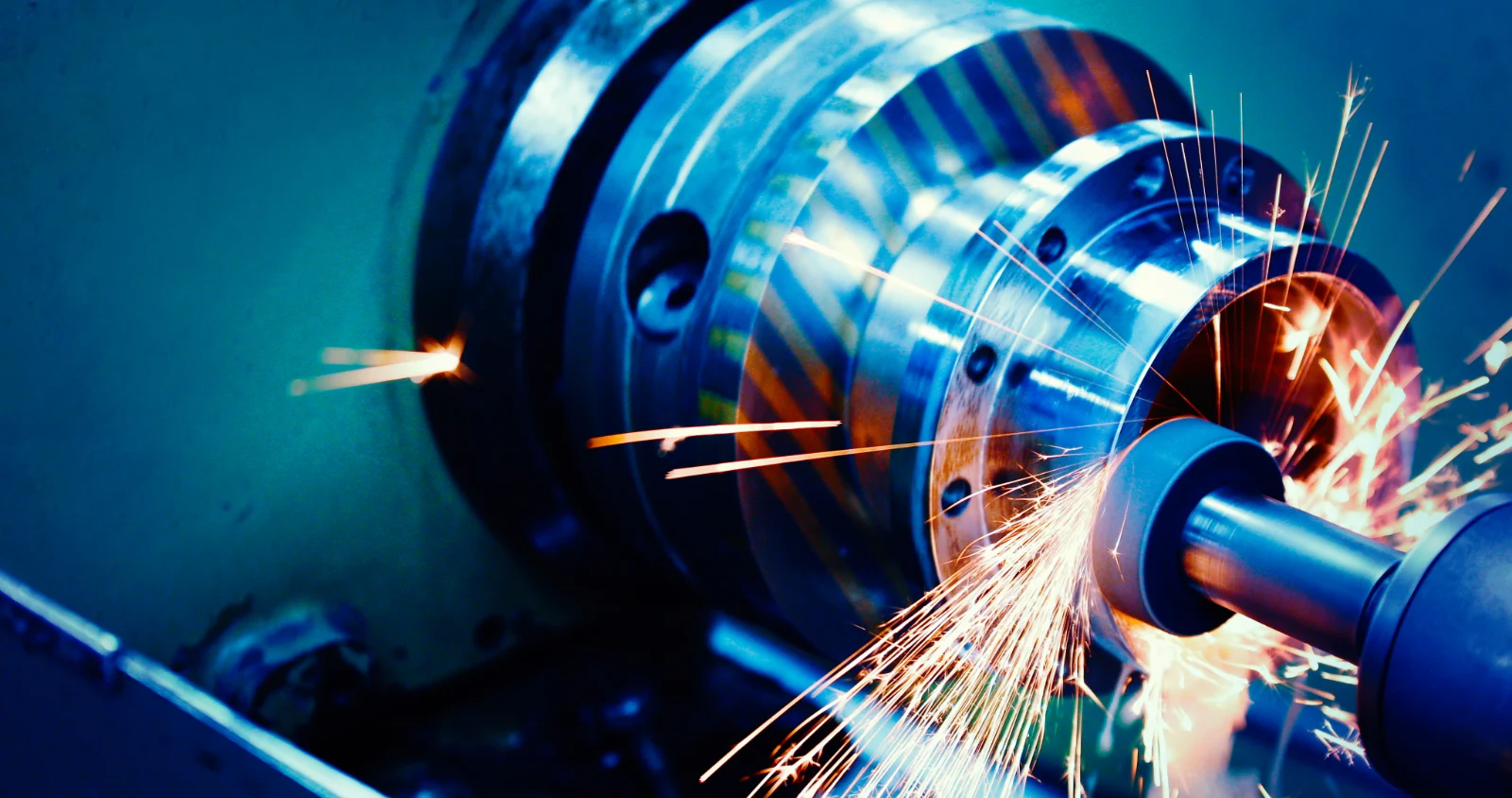 Grinding sparks flying from a workpiece on a turning machine