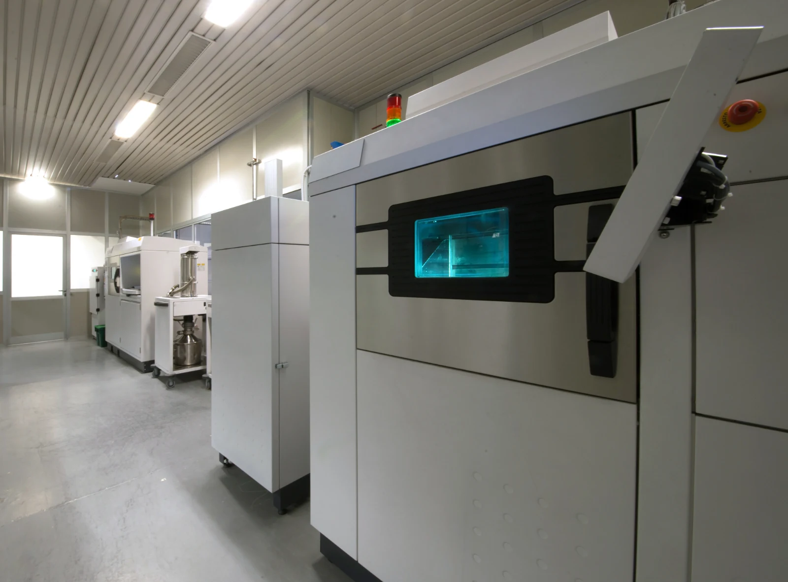 Row of industrial metal 3D printers on the production floor