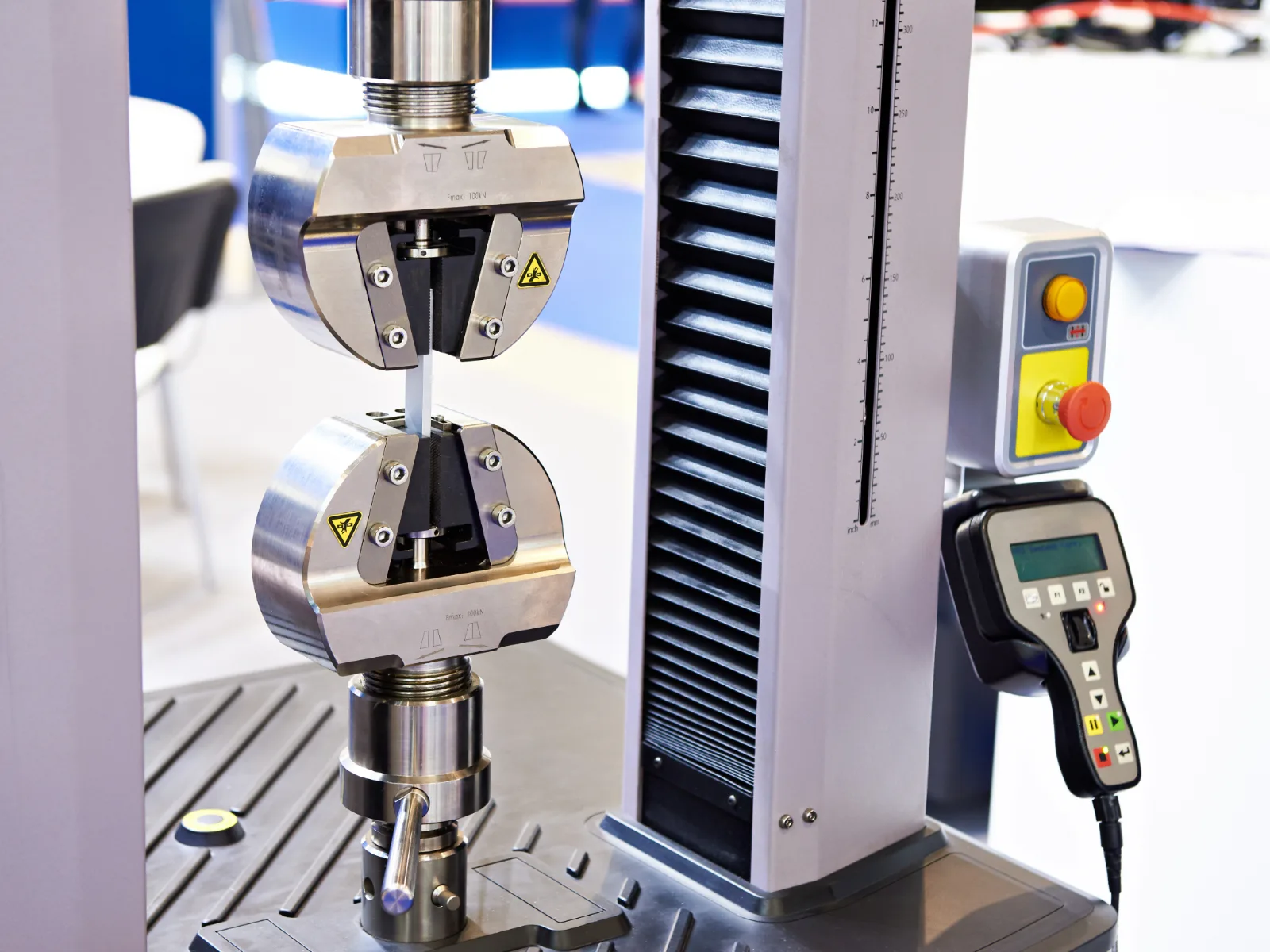 Universal testing machine performing a tensile test on a metal specimen